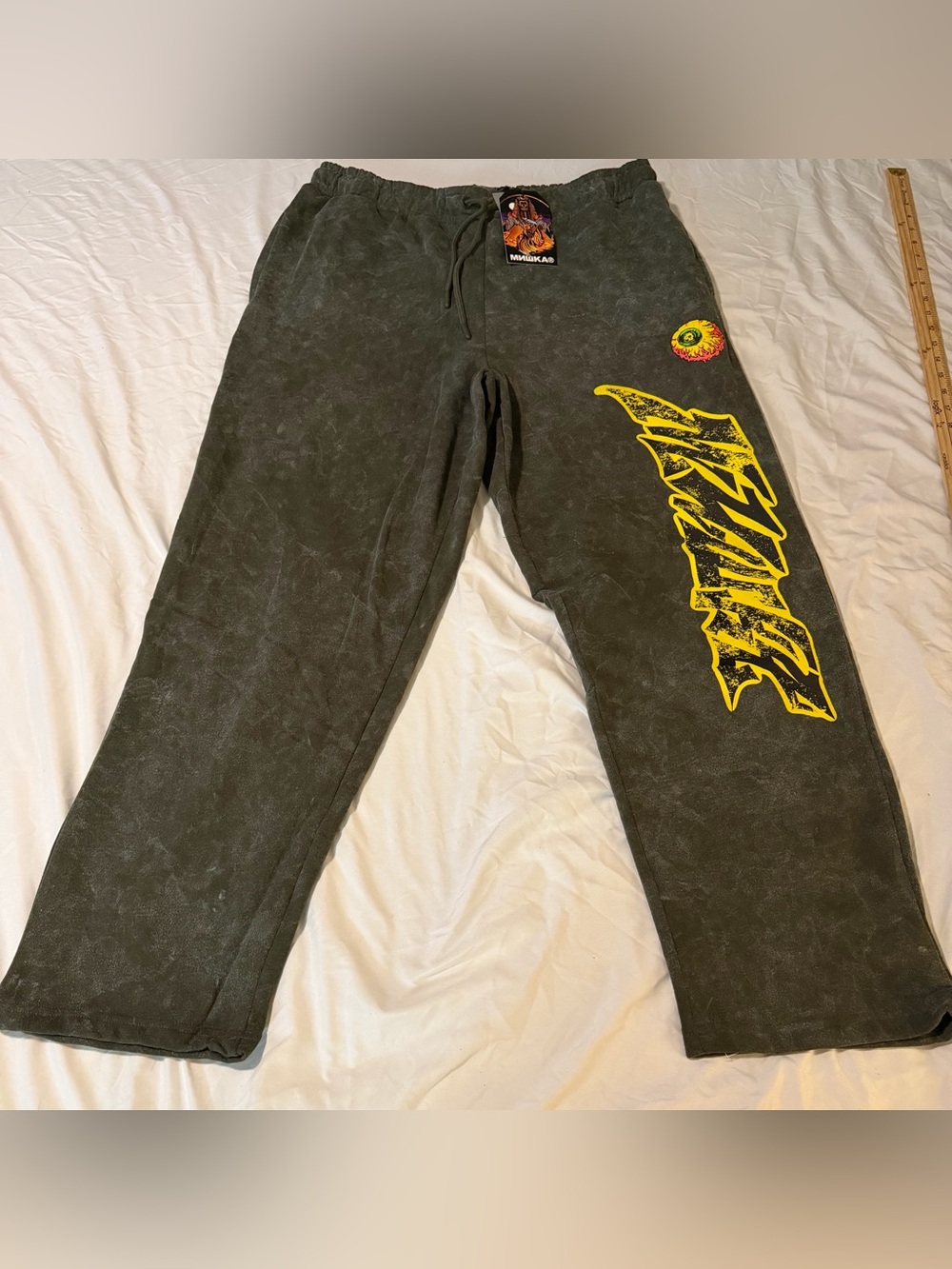 Mishka Black Stonewash Joggers with Yellow Graphic Eye